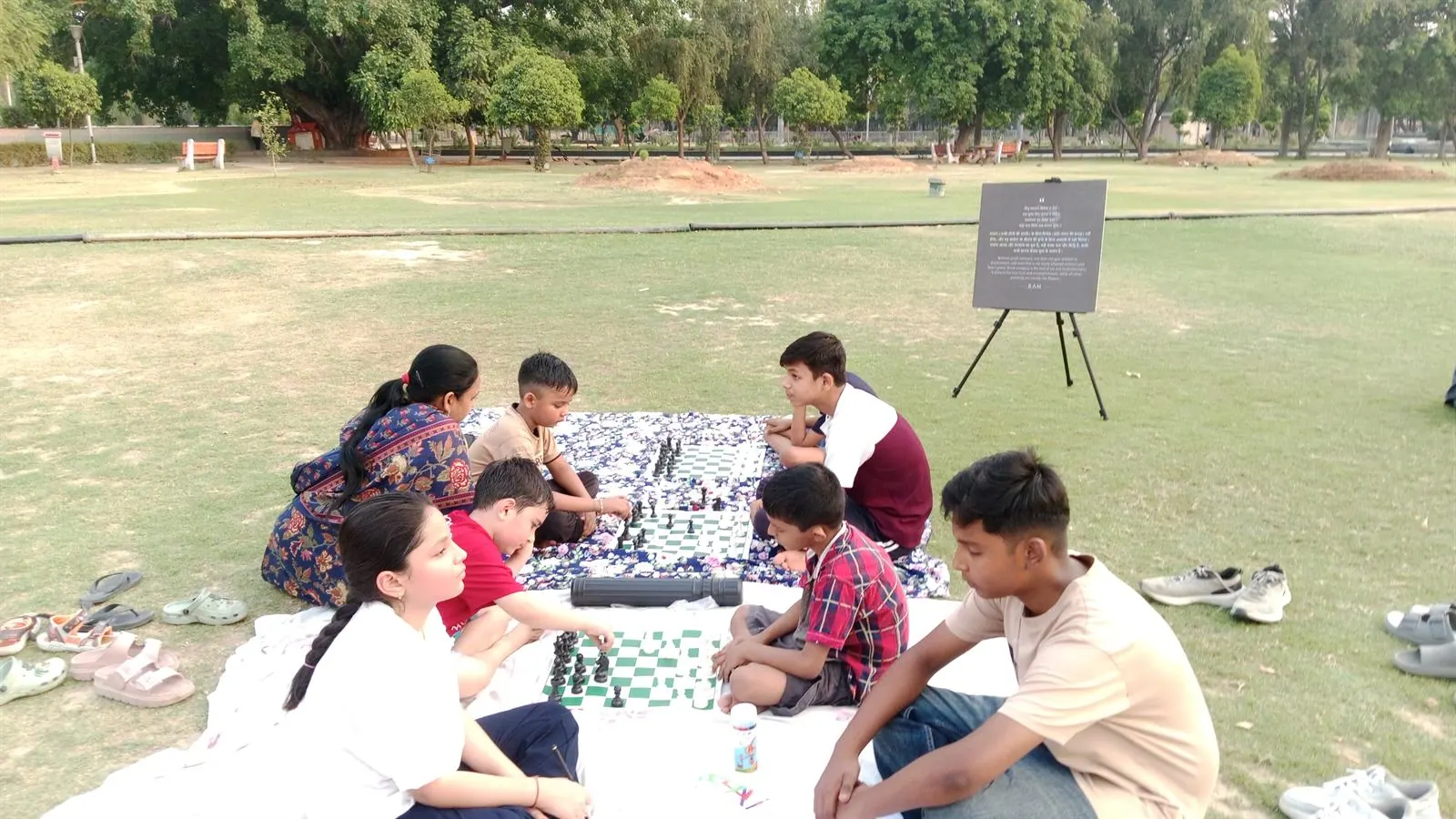 Children playing chess during a Screenless Sunday society session